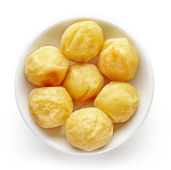 Bowl of potato balls isolated on white, from above