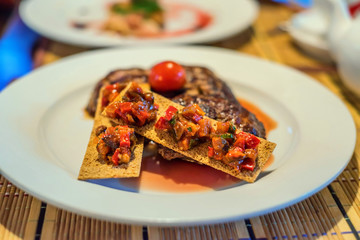 Grilled beef with tomato and bruschetta
