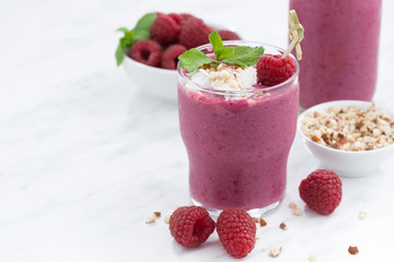 Fresh raspberry smoothie with nuts on a white background