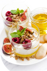sweet yogurt with honey and fresh figs on white background, vertical