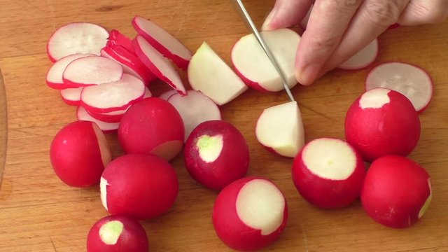 Slicing radish on a rustic wooden table
