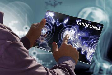 Business, Technology, Internet and network concept. Young businessman working on a virtual screen of the future and sees the inscription: Guidelines