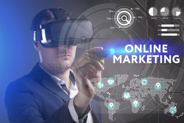 Business, Technology, Internet and network concept. Young businessman working in virtual reality glasses sees the inscription: Online marketing