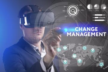 Business, Technology, Internet and network concept. Young businessman working in virtual reality glasses sees the inscription: Change management