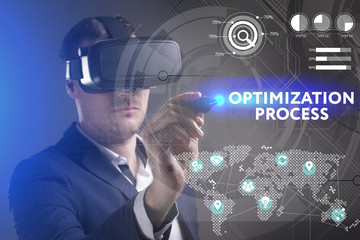 Business, Technology, Internet and network concept. Young businessman working in virtual reality glasses sees the inscription: Optimization process