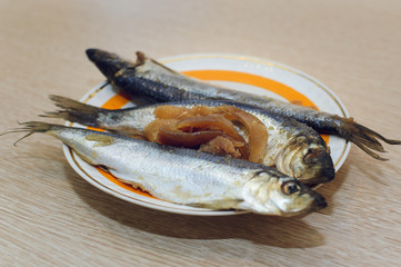 Salted fish Clupea harengus membrane with caviar lies on a plate. Close-up, selective focus.