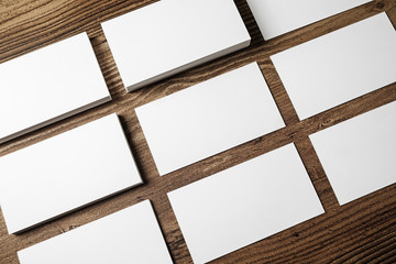 Blank business cards on wooden table background. Blank stationery mockup for branding identity for placing your design. Top view.