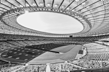 rows of yellow and blue stadium seats on soccer field stadium, black and white - obrazy, fototapety, plakaty