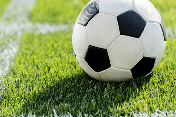 close up view of soccer ball on grass in corner kick position on soccer field stadium