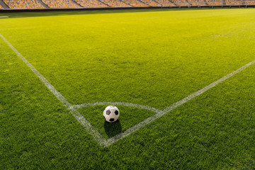 soccer ball on grass in corner kick position on soccer field stadium