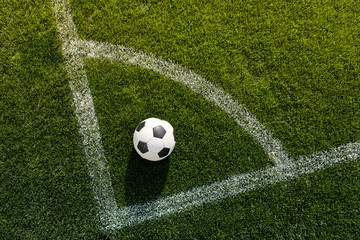 soccer ball on grass in corner kick position on soccer field stadium