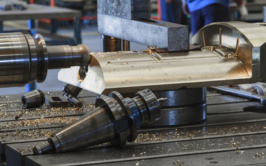 Milling head cutting on bronze material, Milling metalworking process. Industrial CNC metal machining by horizontal boring machine. .