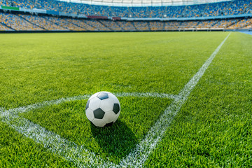 Fototapeta na wymiar soccer ball on grass in corner kick position on soccer field stadium