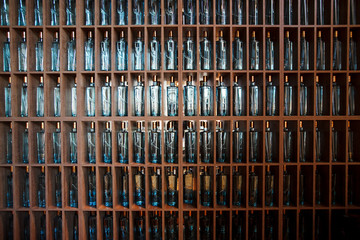 Background of the bottles on wooden shelves. Texture
