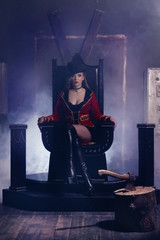 Beautiful woman trainer in a circus suit on the throne