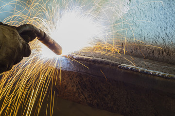 Closeup welding steel by MIG/MAG weld (Argon welding) in industrial factory. - obrazy, fototapety, plakaty