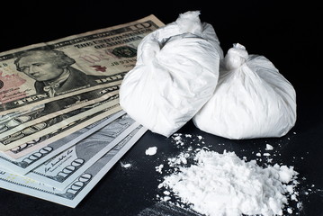 Drugs and money on a black background