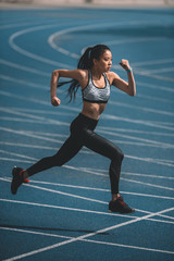 asian sportswoman training on running track stadium, young girl running concept