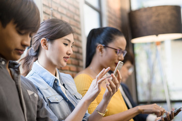 Group of asian Business Friends Sitting Chair Using Modern Gadgets.Business Startup Friendship Teamwork Concept.Creative People Working Together Sale Project.Coworking Wide