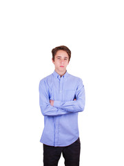 Serious or sad young man. Portrait of handsome teen boy in blue shirt keeping arms crossed, isolated on white background