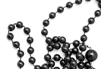 Black beads on a white background