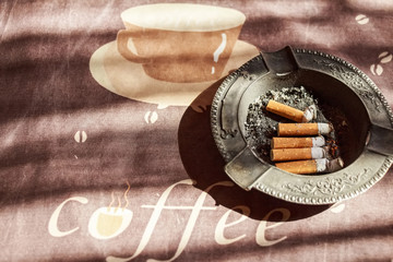 Cigarettes in black metal ash tray