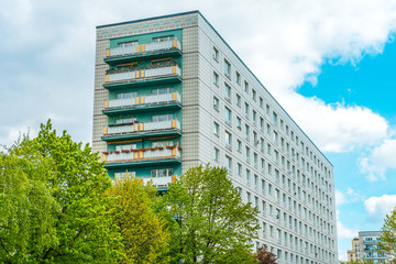 green and white colored plattenbau building in the heart of berlin
