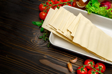 dried uncooked lasagna pasta sheets and ingridients