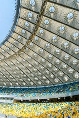 rows of yellow and blue stadium seats on olympic stadium