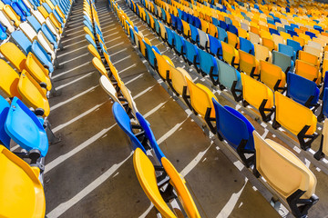 Fototapeta premium rows of yellow and blue stadium seats on soccer stadium