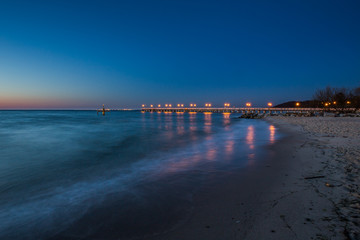 Amazing sunrise on the pier at the seaside. Gdynia Orlowo, Poland