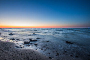 Amazing sunrise on the pier at the seaside. Gdynia Orlowo, Poland