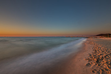 Amazing sunrise on the pier at the seaside. Gdynia Orlowo, Poland