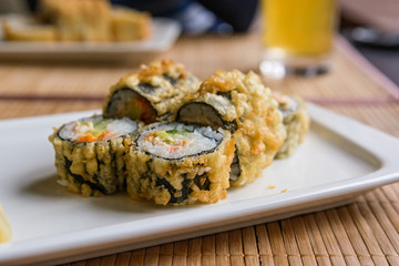 Hot fried Japanese rolls on plate