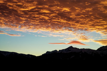 Lenticular (lens-shaped) clouds after sunset. Caucasus. Russia. The Caucasian reserve. Plateau of Lagonaki