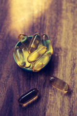 Fish oil capsules with omega 3 and vitamin D. Healthy diet concept