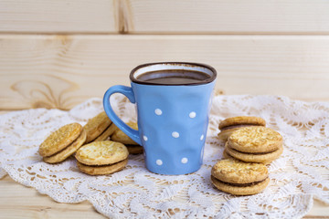 cup of coffee with biscuits on a wooden background
