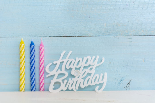 Blue Birthday Candle Isolated On A Blue  Wooden Background