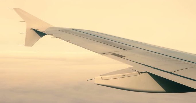 Land and sky as seen through window of an aircraft. Classic view through aircraft window onto wing. Looking through window aircraft during flight