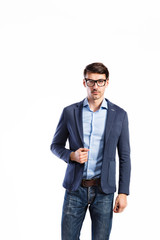 Fototapeta premium Handsome young man in blue jacket. Studio shot, isolated.