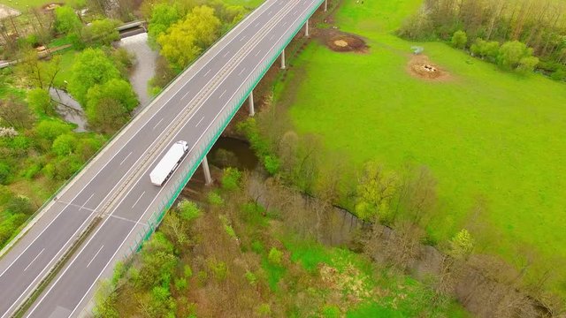 Aerial view of bridge over Radbuza River and green pastures. Highway D5 with traffic near Pilsen, Czech republic, Central Europe. Transportation and sustainable development concept. 
