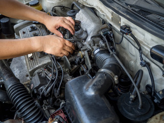 Obraz na płótnie Canvas Car mechanic working in auto repair service