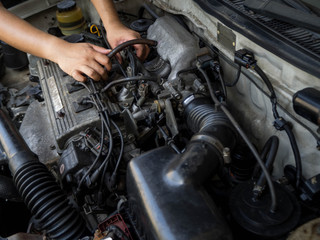 Fototapeta na wymiar Car mechanic working in auto repair service