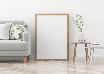 Interior poster mock up with vertical frame standing on the floor in scandinavian style livingroom. 3d rendering. © marina_dikh