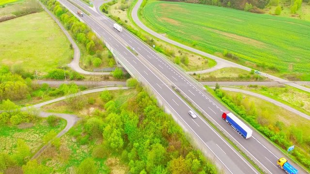 Aerial view of bridge over Radbuza River and railroad with passenger train. Highway D5 with traffic near Pilsen, Czech republic, Central Europe. Transportation and sustainable development concept. 