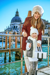 Fototapeta na wymiar mother and child in Venice showing thumbs up and taking selfie