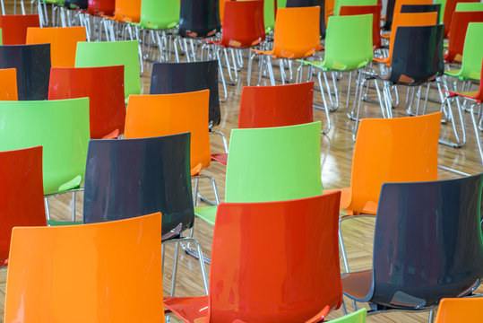 Colored chairs in hall.