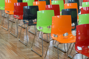 Colored chairs in hall.