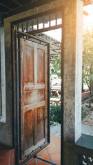 The retro style ancient and antique wooden door opening and view of vintage garden .
