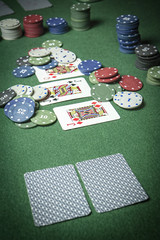 cards poker deck English, poker chips stack on green table